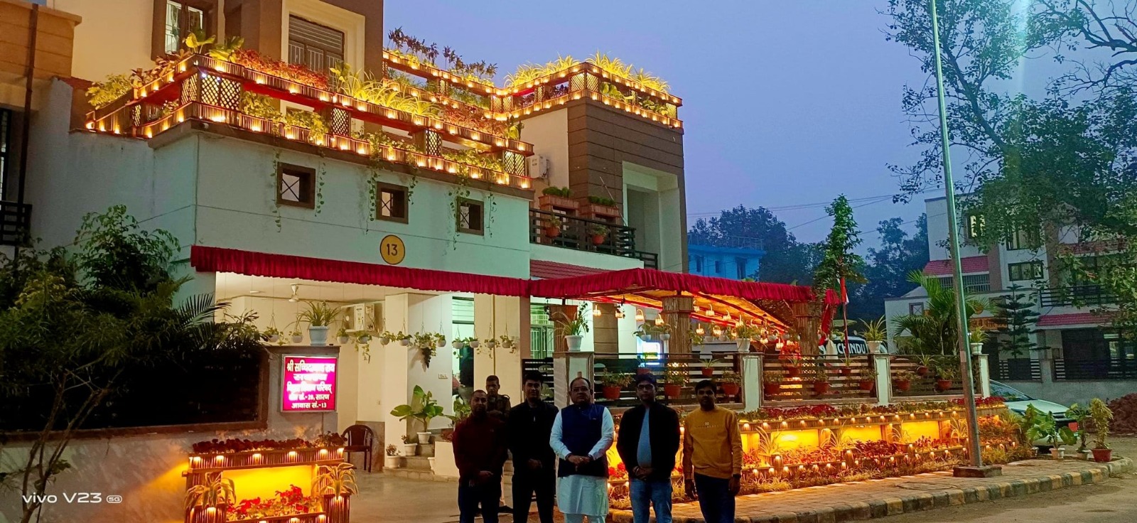 KarmYog Vatika at the MLC residence in Patna, illuminated at dusk with a rooftop garden and warm lighting